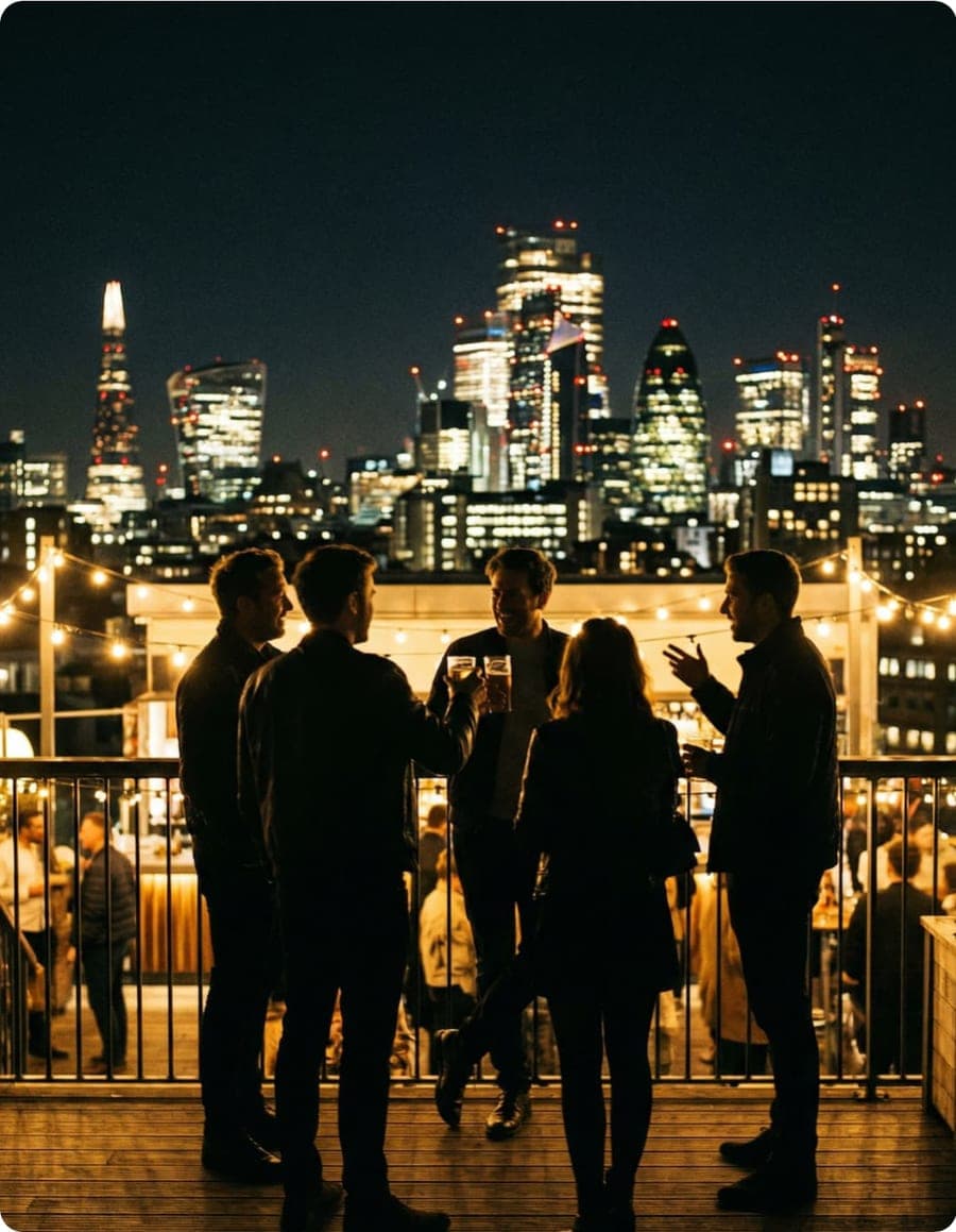 Friends having drinks on a London rooftop at golden hour